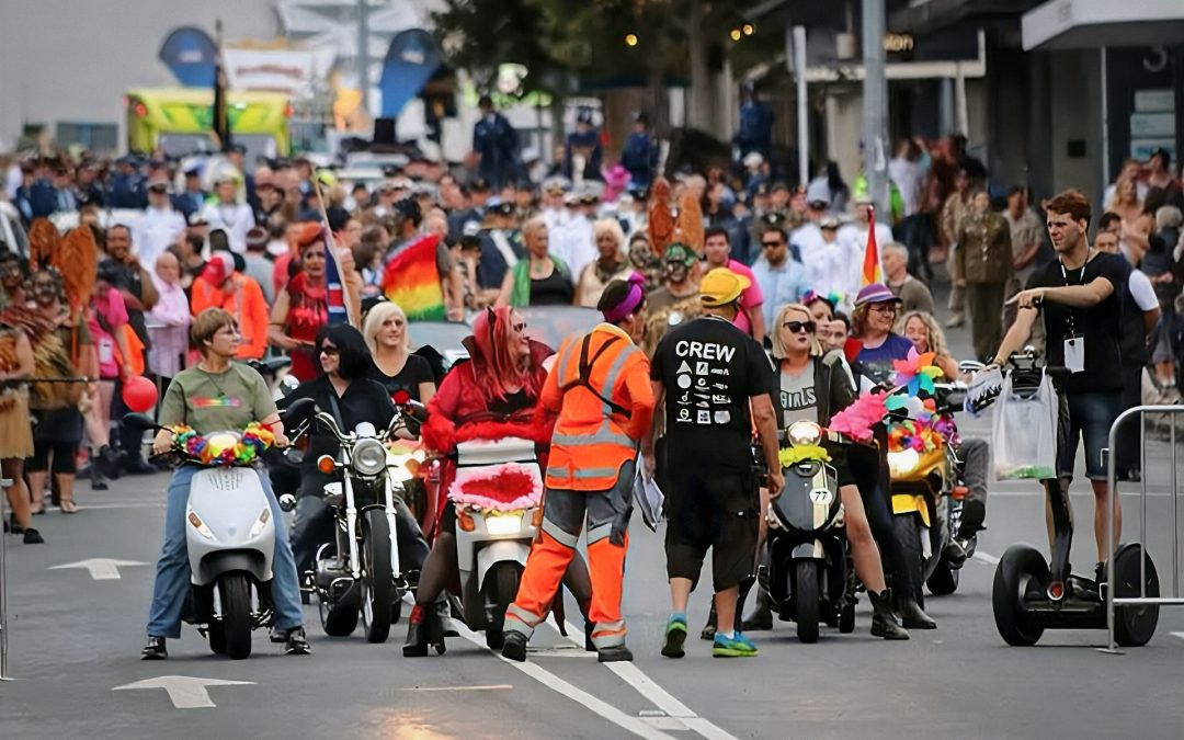 Traffic management worker overseeing a parade of motorcycles