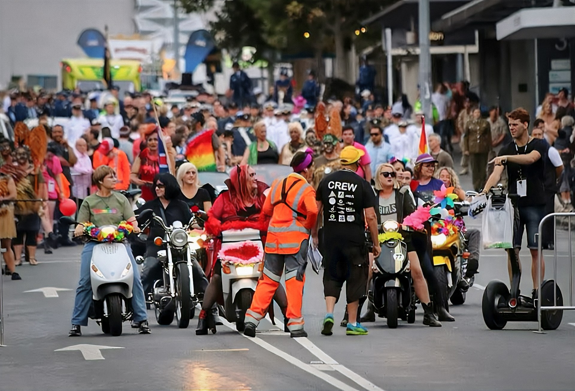 Traffic management worker overseeing a parade of motorcycles